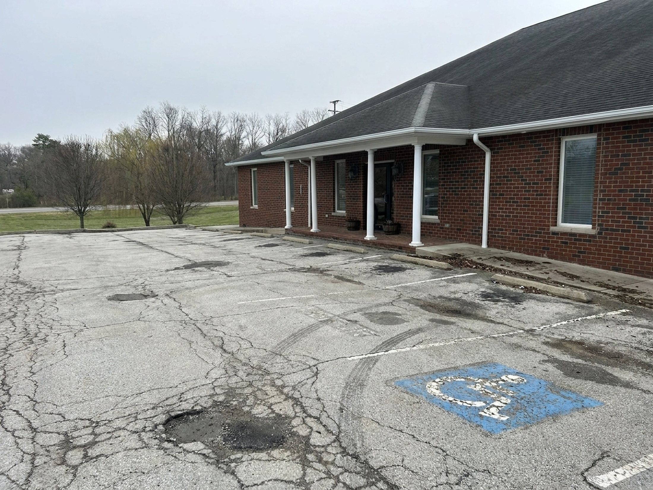 Worn, faded parking lot before LCS Striping work