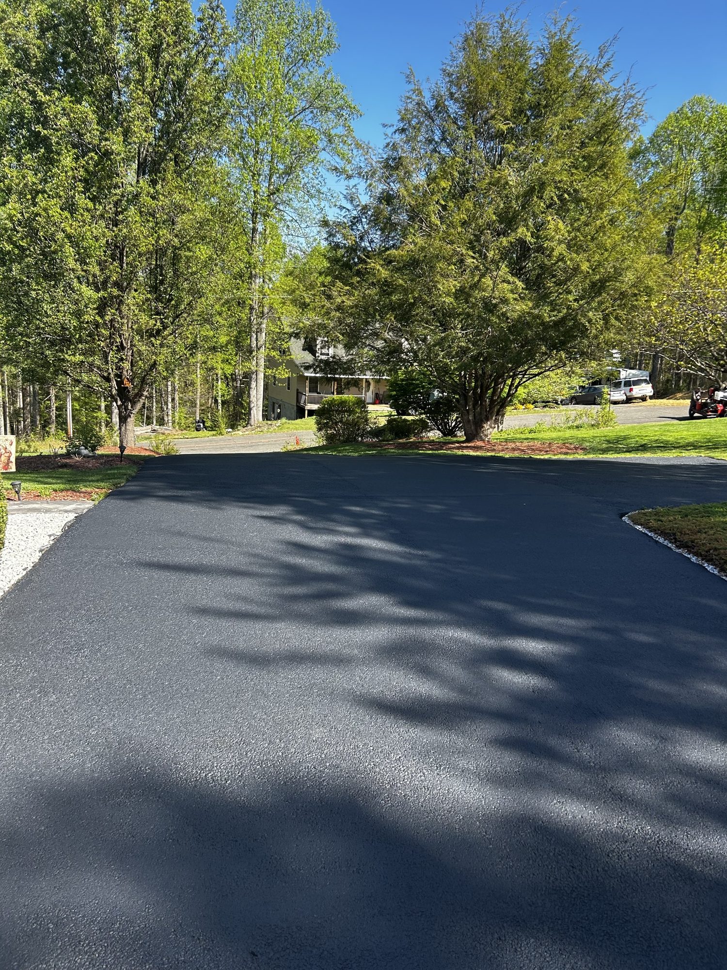 Freshly sealcoated driveway with a deep-black finish