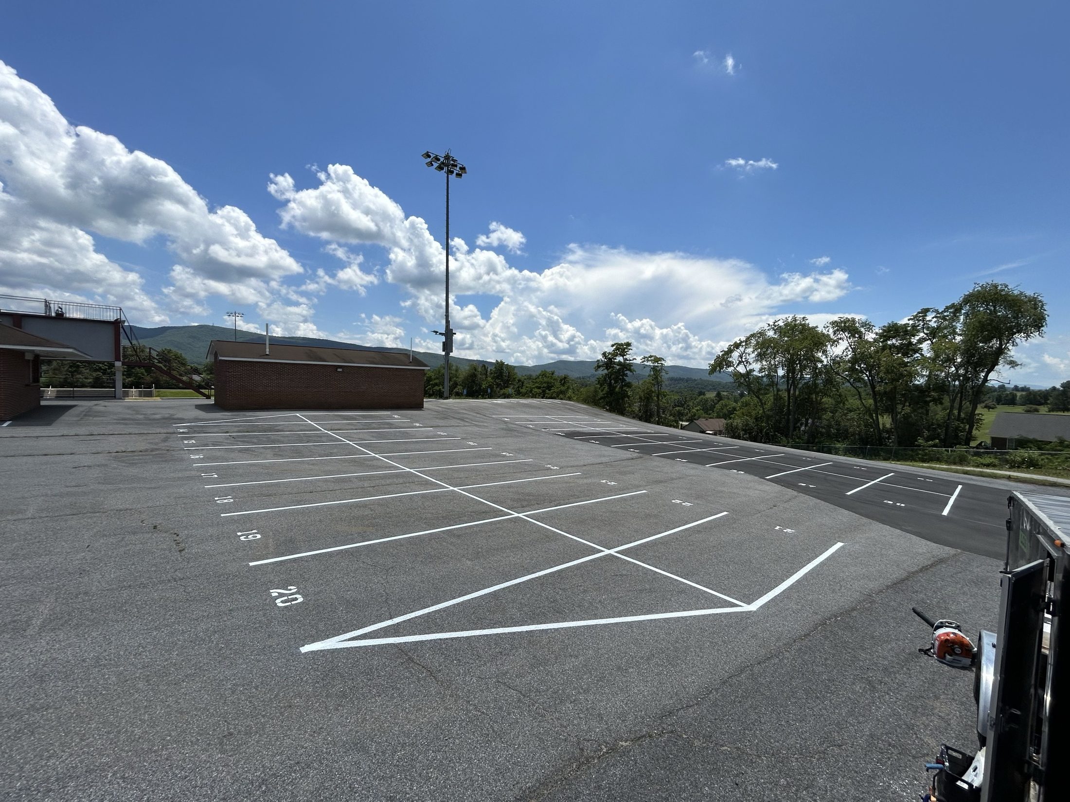 Numbered parking stalls on a hilltop with mountain views