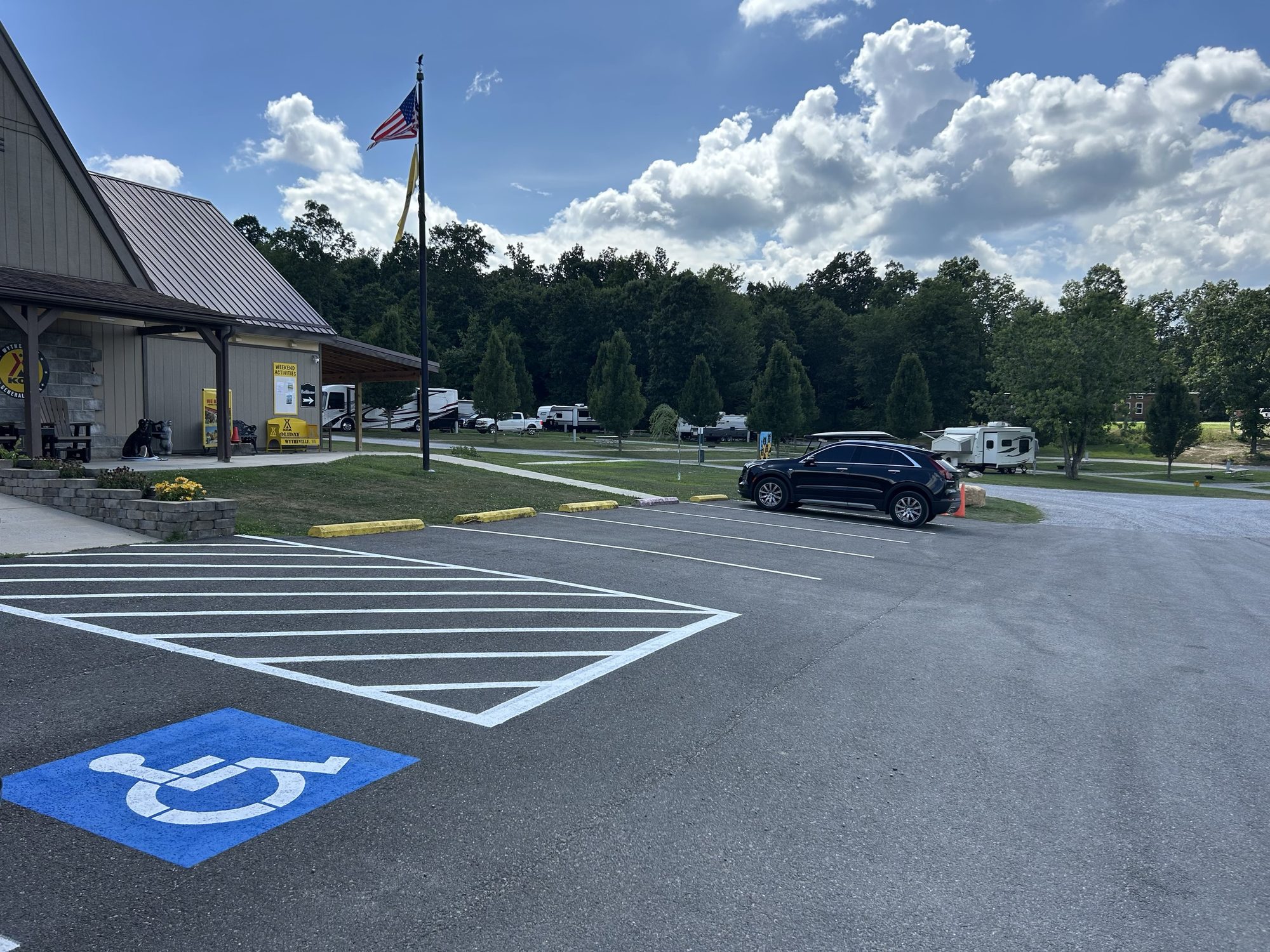 Campground parking with ADA stall and US flag
